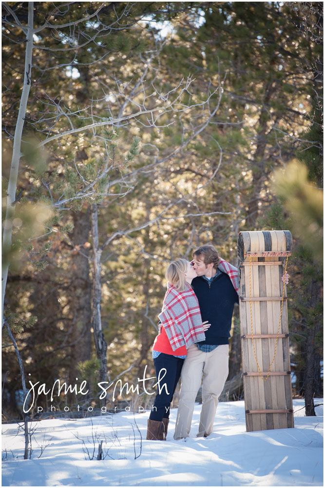 Stealing a kiss before sledding down the hill