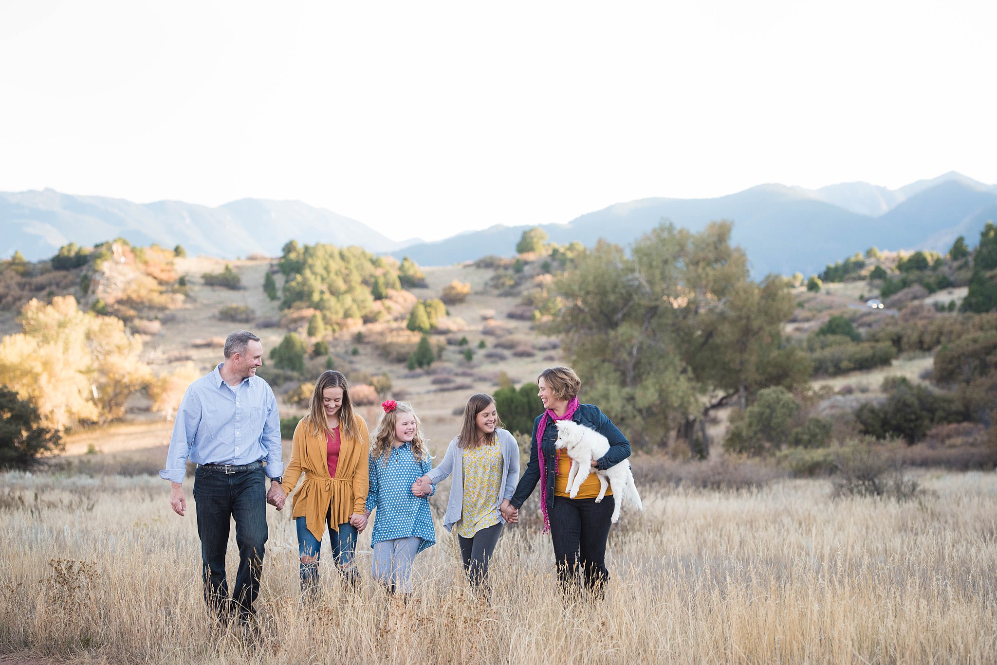 Family of 5 walking through a field near colorado springs