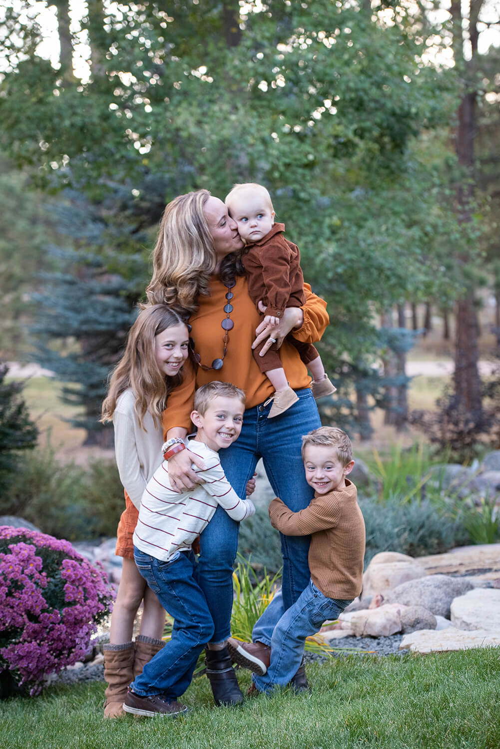 4 kids hugging and playing on mom near Colorado Springs Toy Stores
