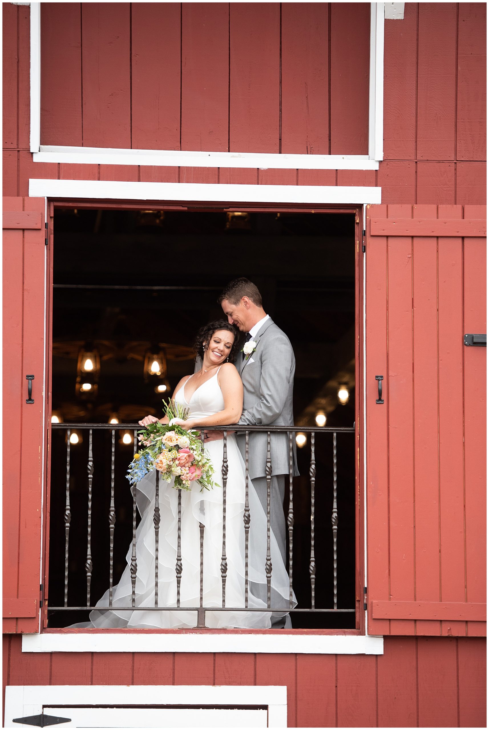 bride and groom on the balcony of Crooked Willow Farms Wedding venue