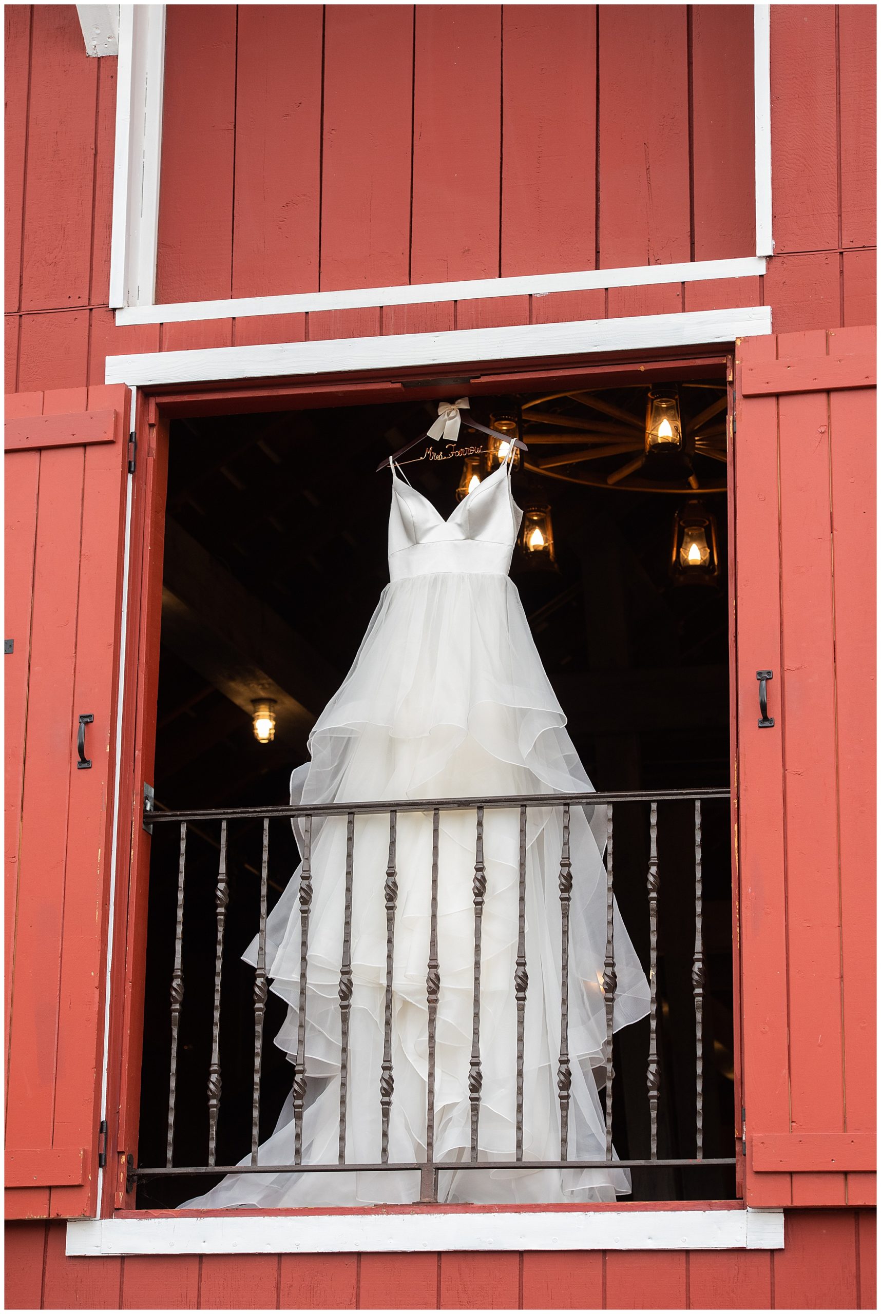 wedding dress hanging on the balcony of the Crooked Willow Farms Wedding venue