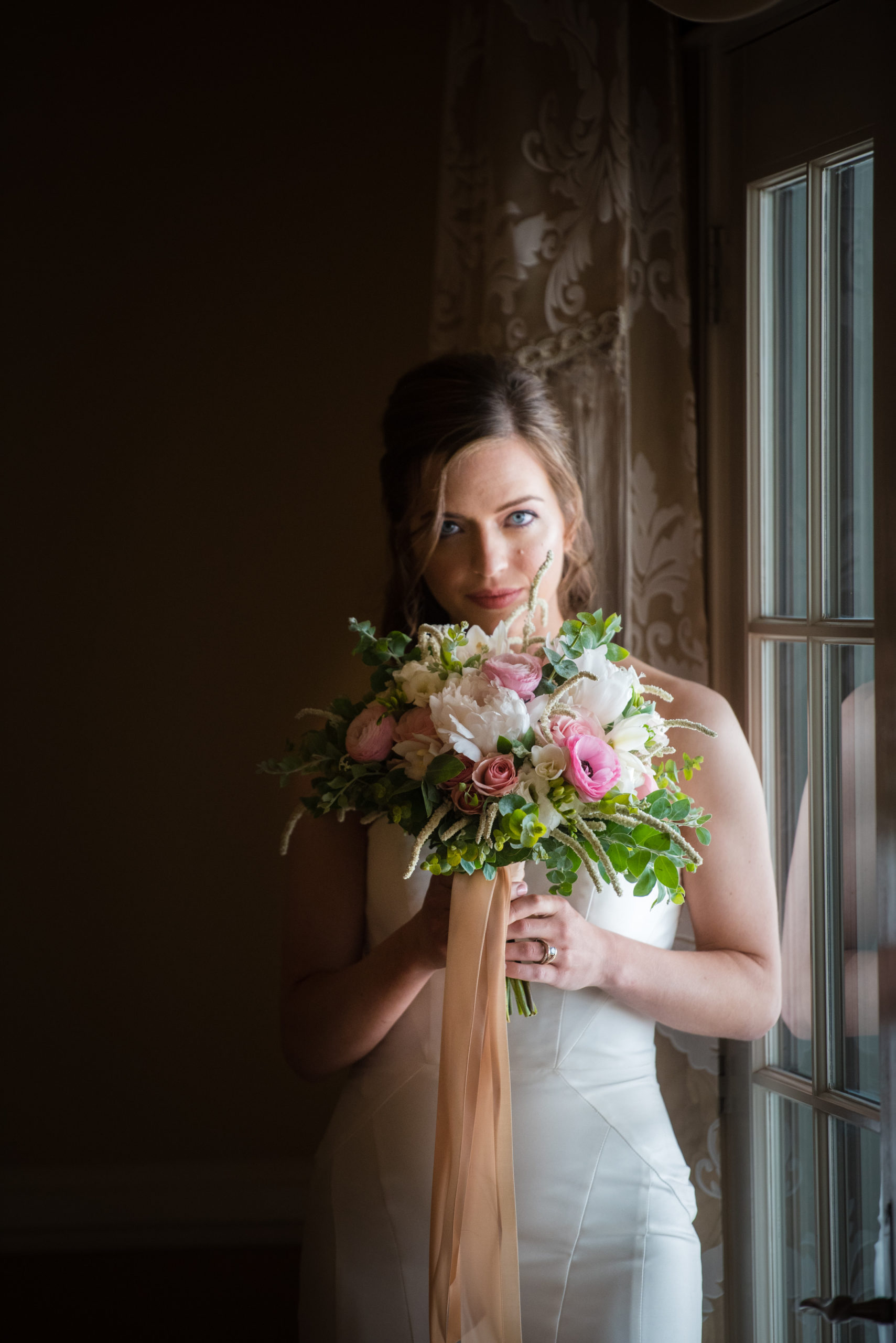 bride smelling her bridal bouquet at Flying Horse Ranch Wedding venue