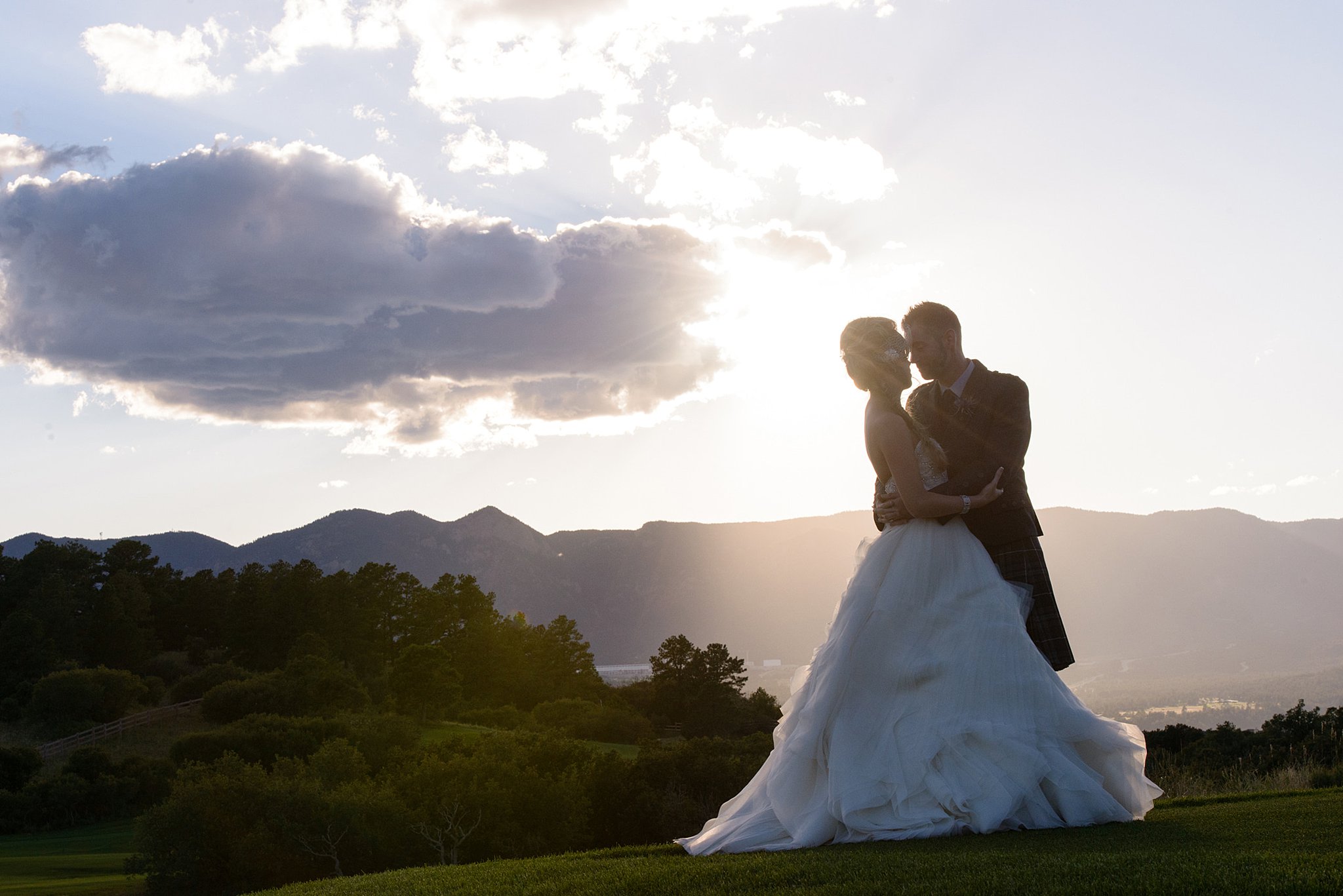 bride and groom holding each other close at sunset Perry Park Country Club Wedding