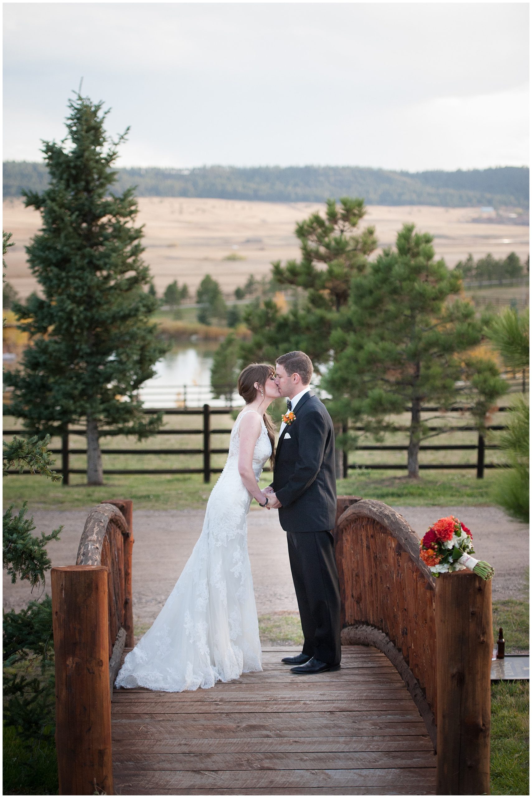 bride and groom sharing a kiss at Spruce Mountain Ranch Wedding venue