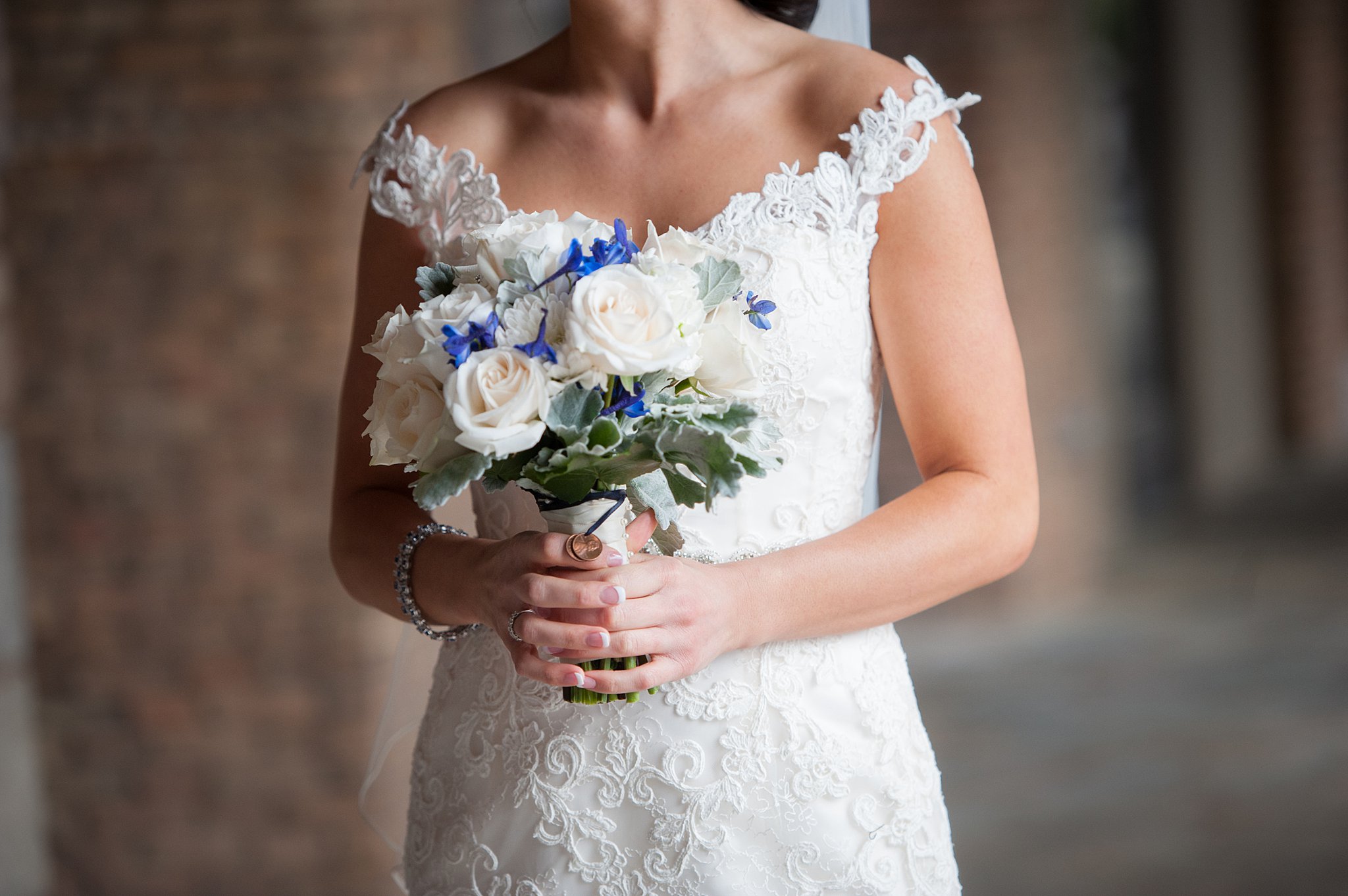 Bride in lace wedding gown hold her bouquet heath house venue