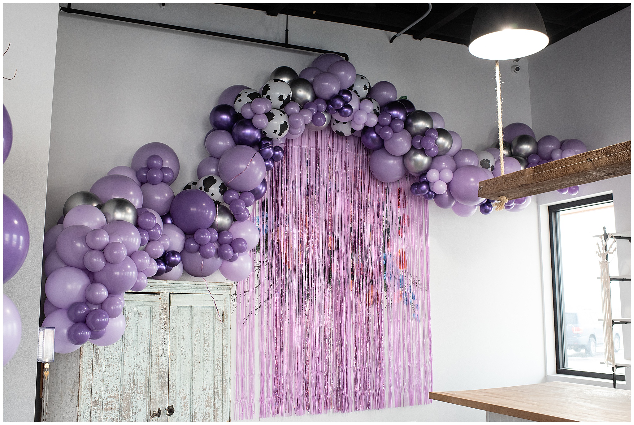 balloons line the wall of a birthday party