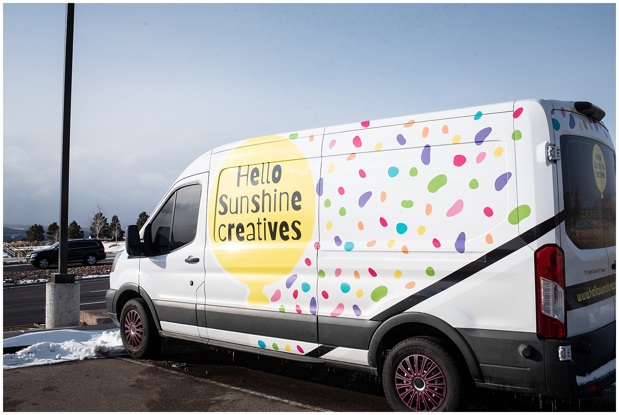 Hello Sunshine Creative sprinter van sits parked in a parking lot balloons colorado springs co