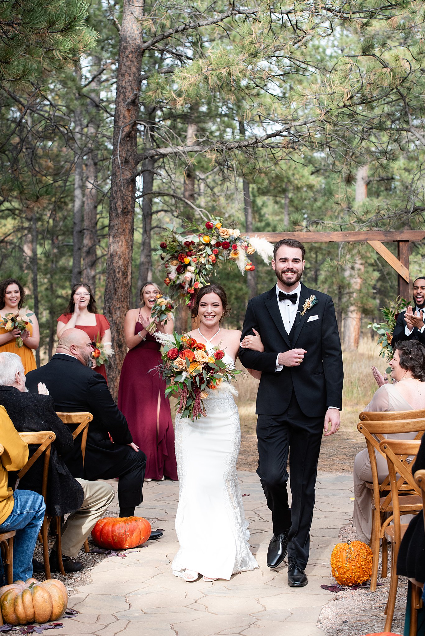 Newlyweds walk down the aisle at their reception in one of the small wedding venues in colorado springs