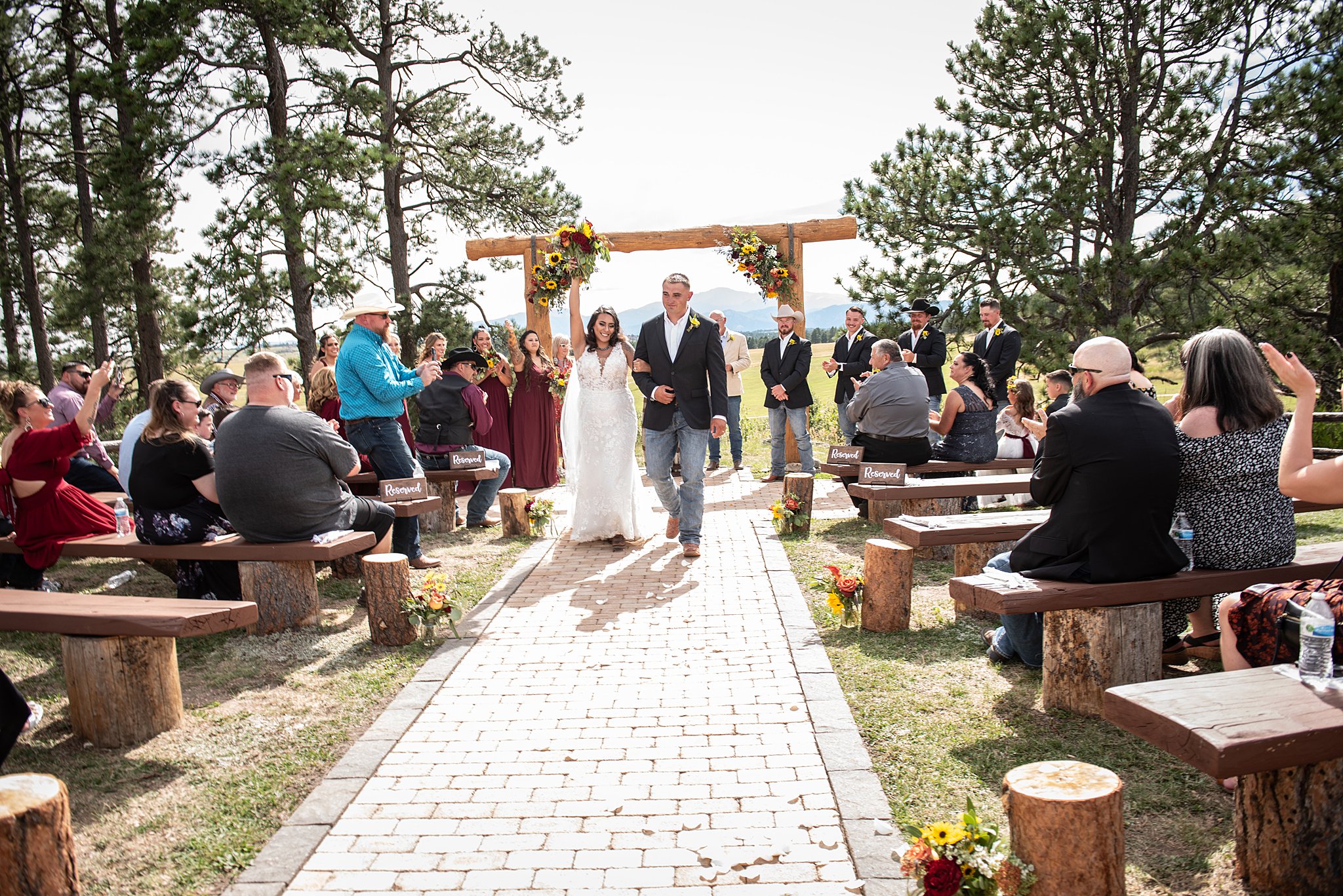 Newlyweds walk back up the aisle after their younger ranch wedding ceremony
