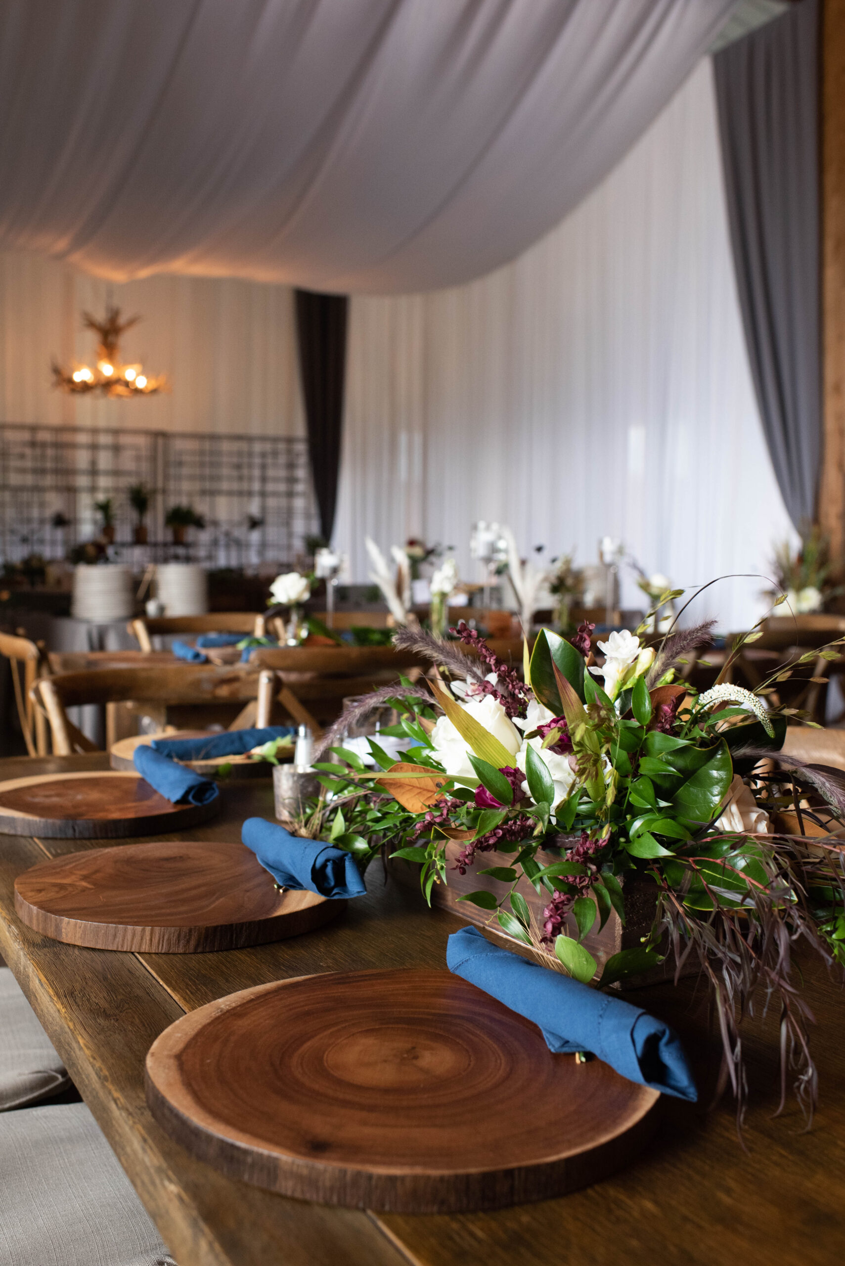 Details of a Spruce Mountain Ranch wedding reception table set up with unique centerpiece and blue napkins