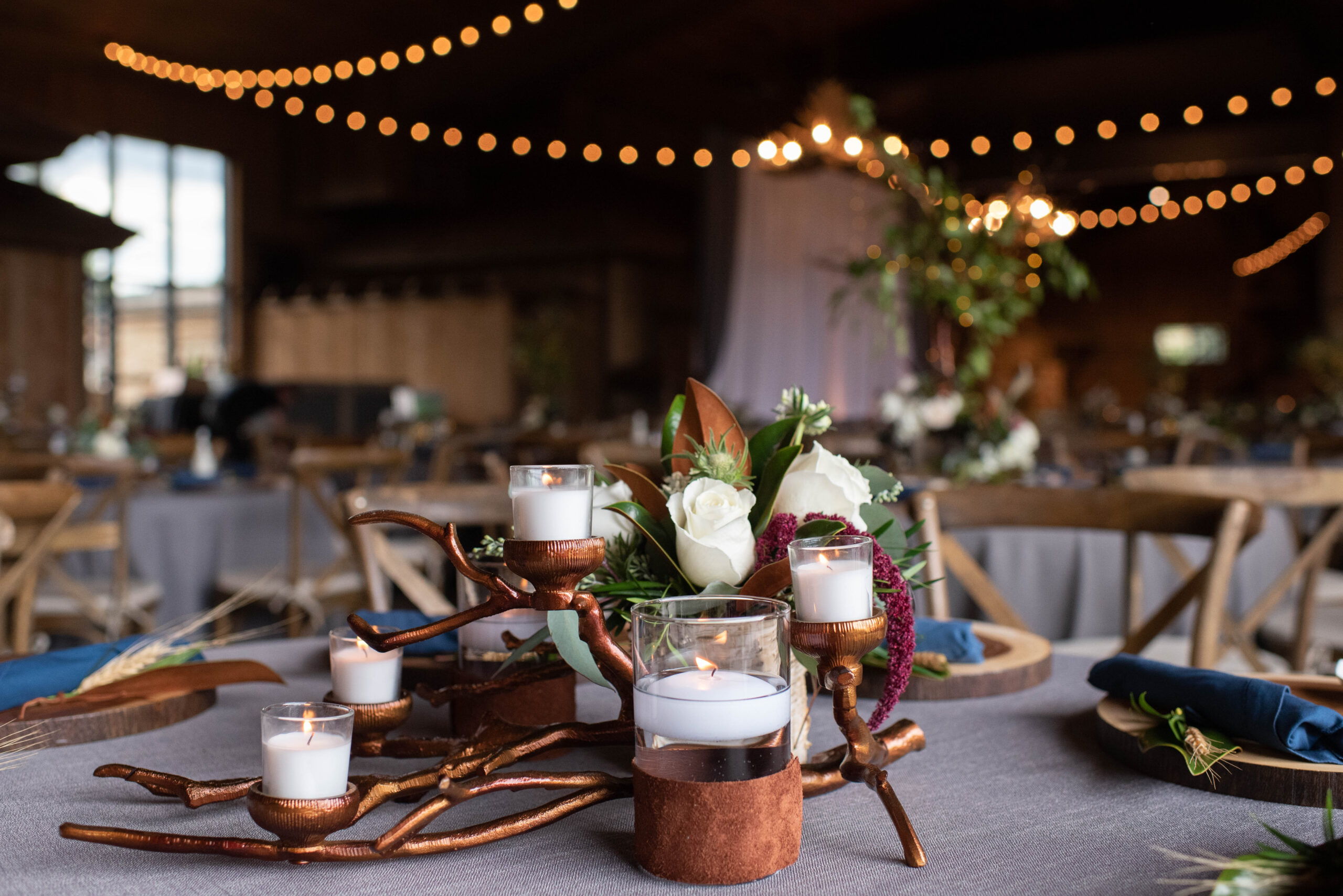 A truly unique wedding reception centerpiece with bronze candle holder