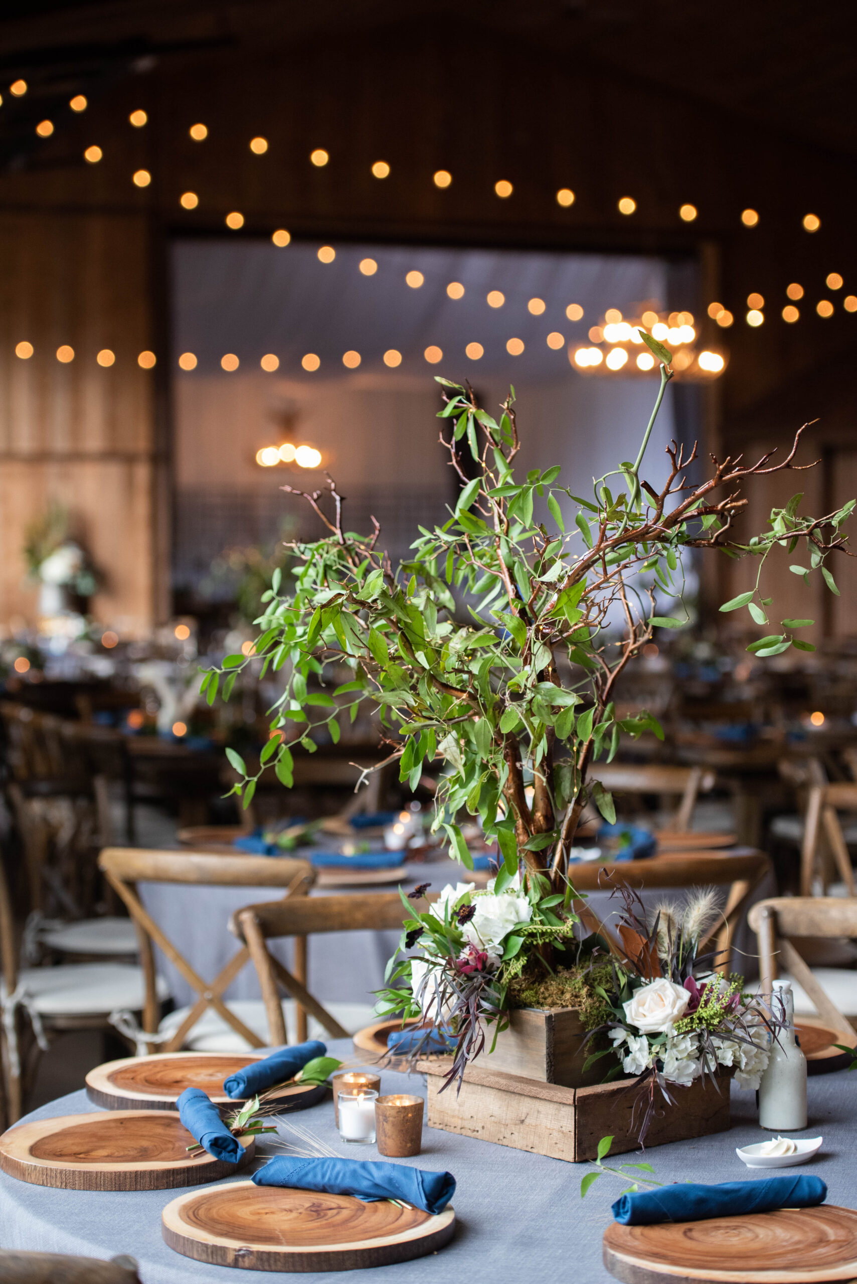 Details of a floral centerpiece with a small tree and white flowers at the Spruce Mountain Ranch wedding venue