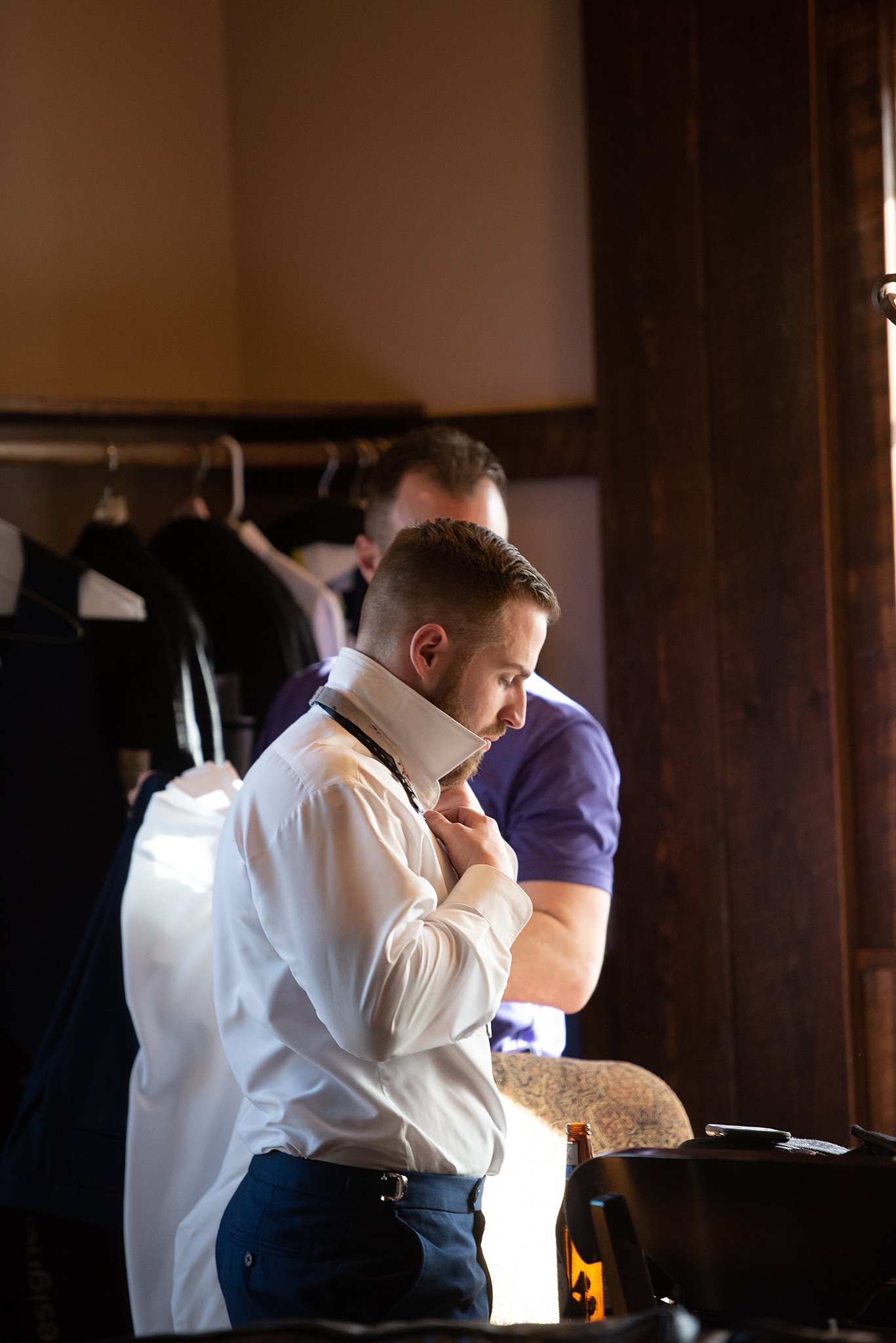 A groom gets ready with his groomsmen