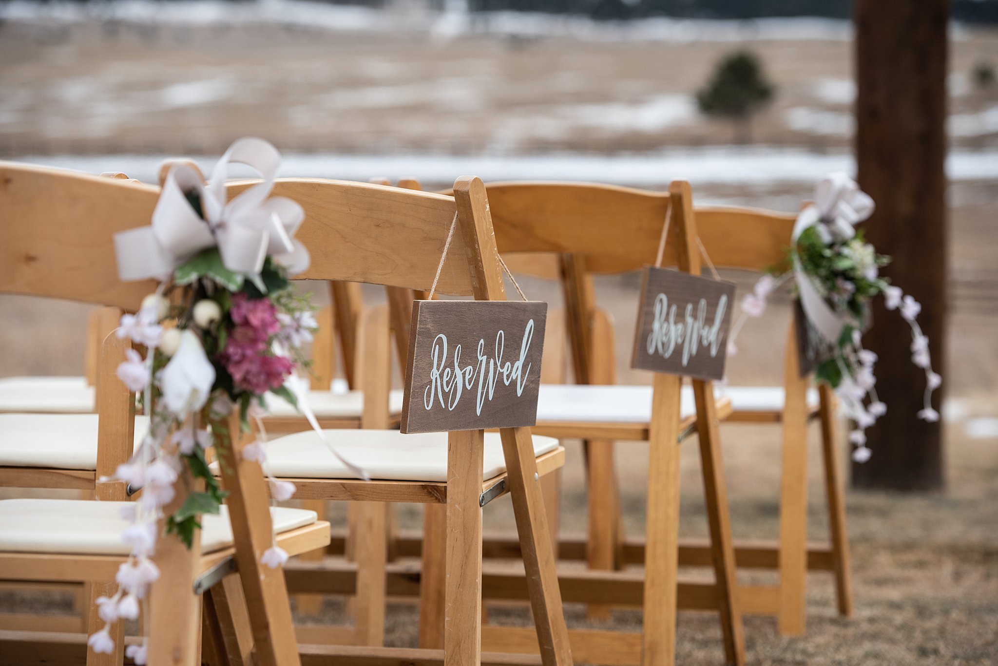 Details of reserved signs hanging on wooden chairs for a ceremony