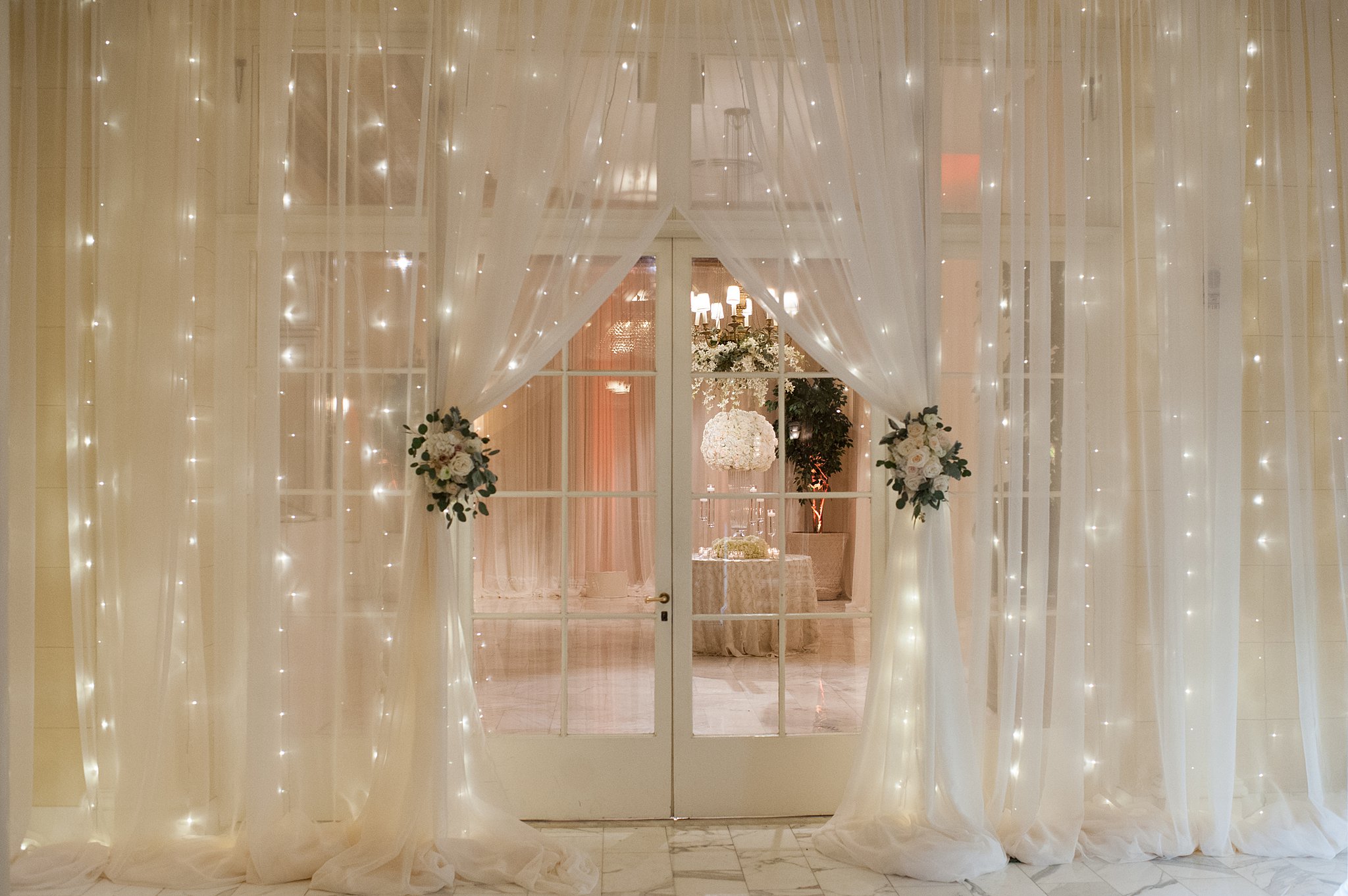 A view of the entrance with white drapes filled with lights at The Broadmoor Wedding venue