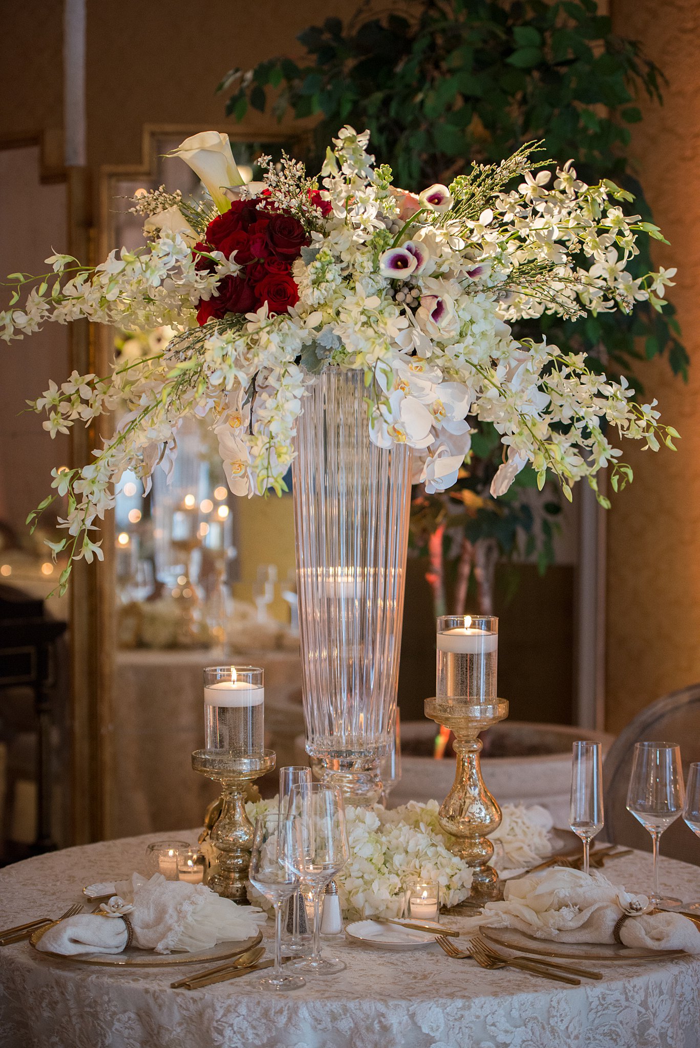 Details of a wedding reception table with lace linen and tall floral at The Broadmoor Wedding venue