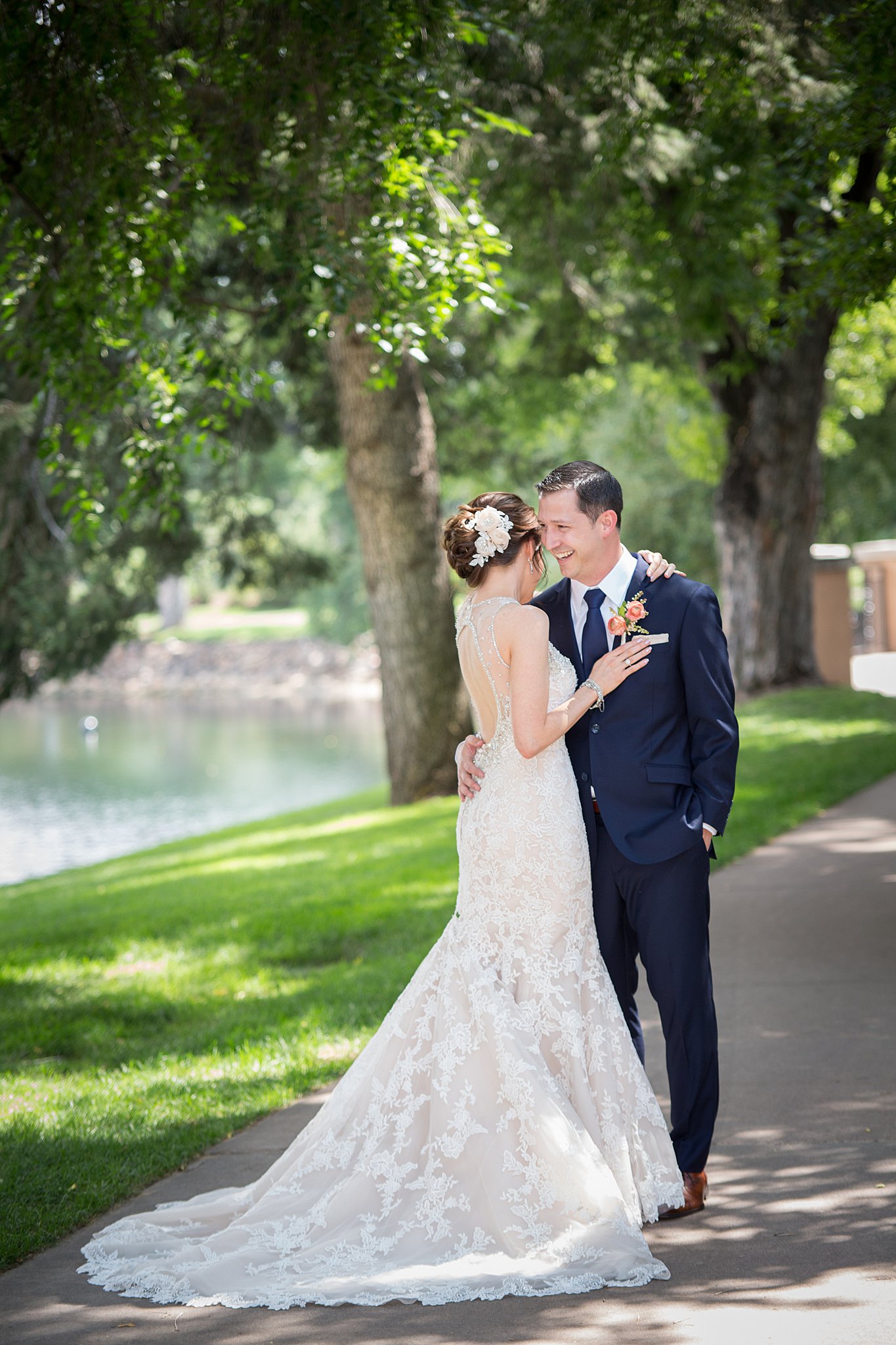 Newlyweds snuggle and laugh in the sidewalk at The Broadmoor Wedding venue