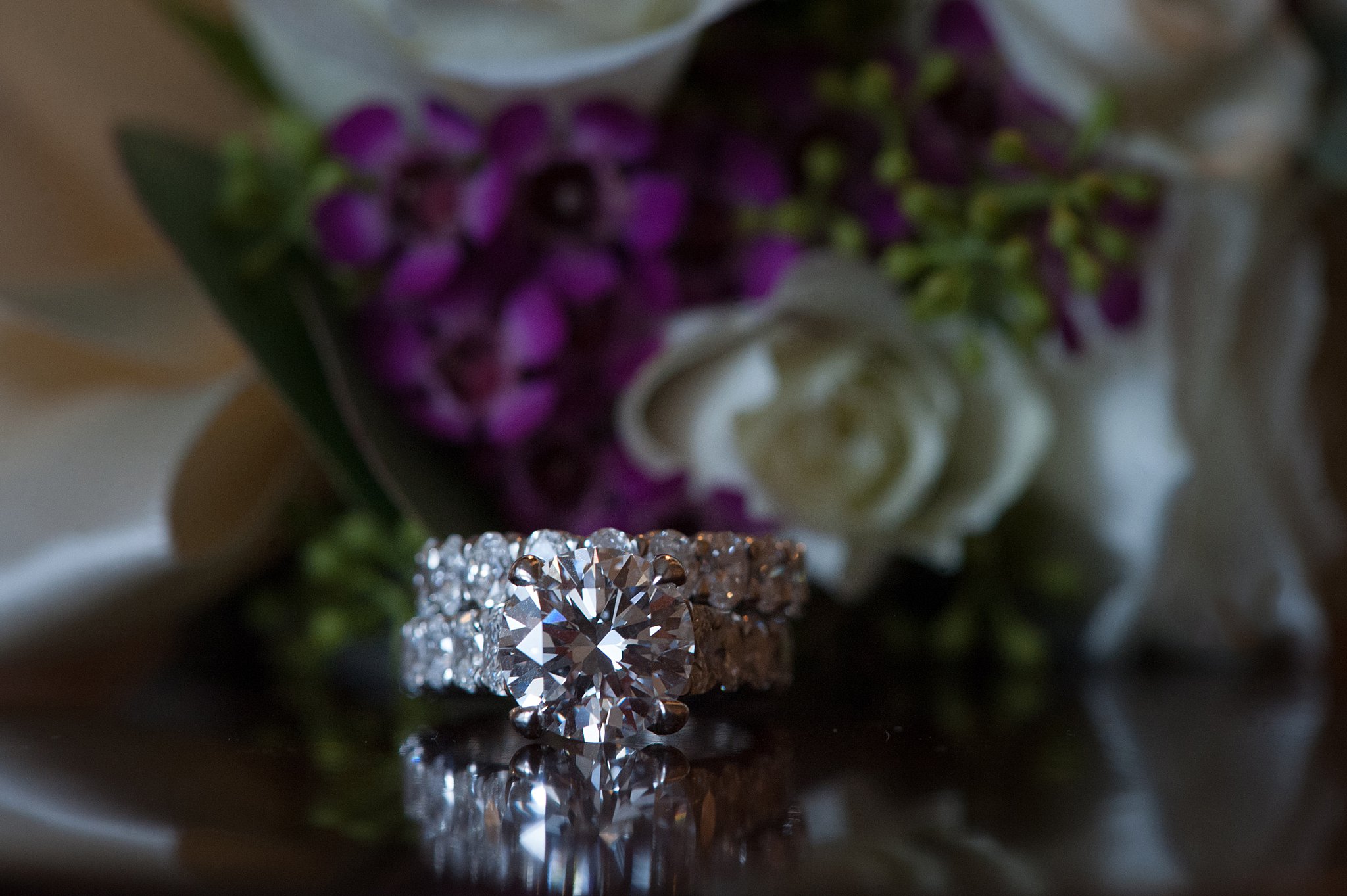 Details of a diamond engagement ring and wedding band on a table